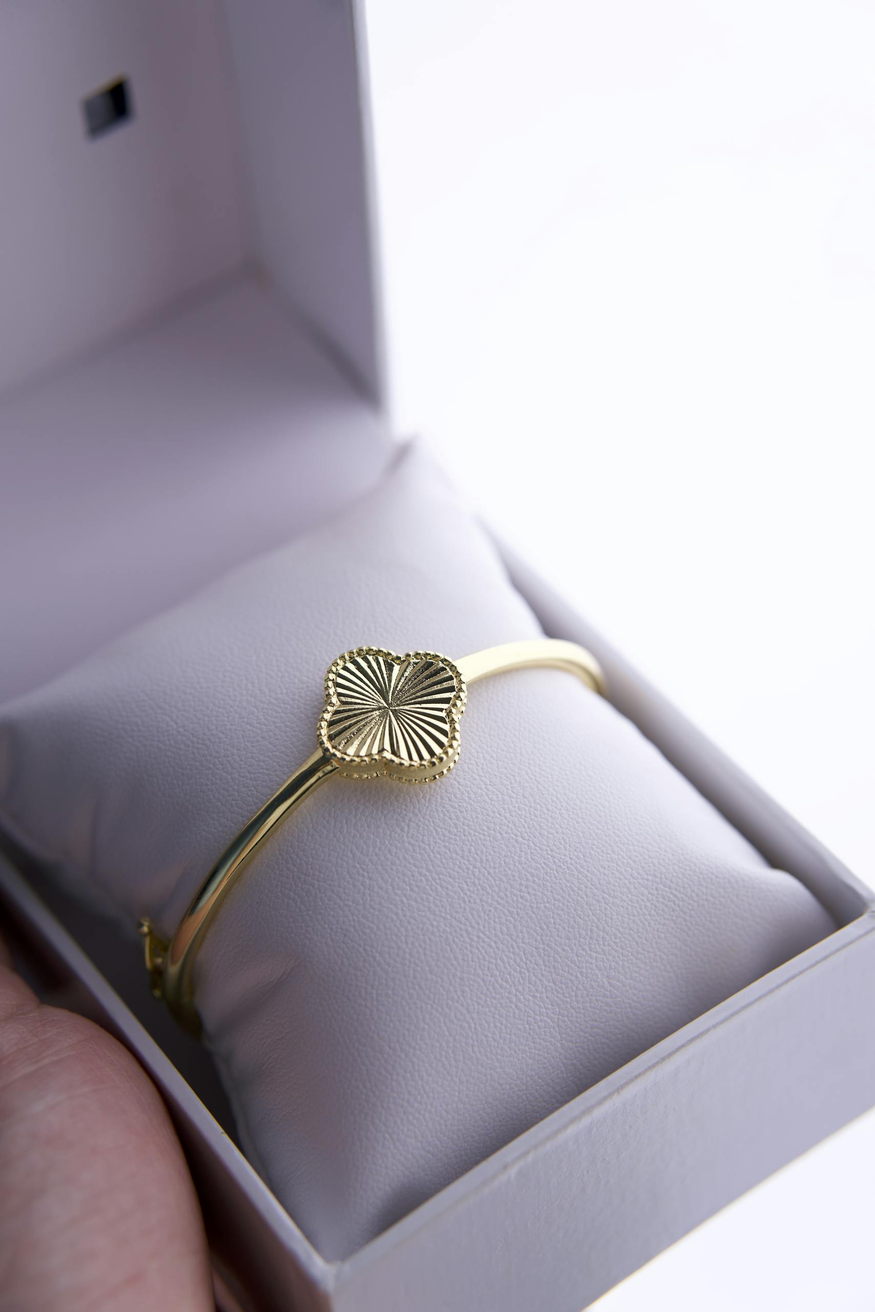 Elegant gold bracelet featured in a luxurious gift box, perfect for special occasions.